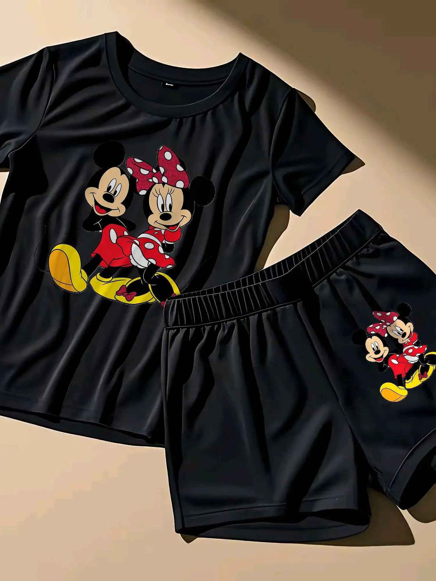 A Two-Piece Outfit Featuring a Printed Short-Sleeve T-Shirt with Dropped Shoulders And Cropped Leggings, Designed for Plus-Size Women, Licensed with Mickey And Minnie. Lady T Fashions