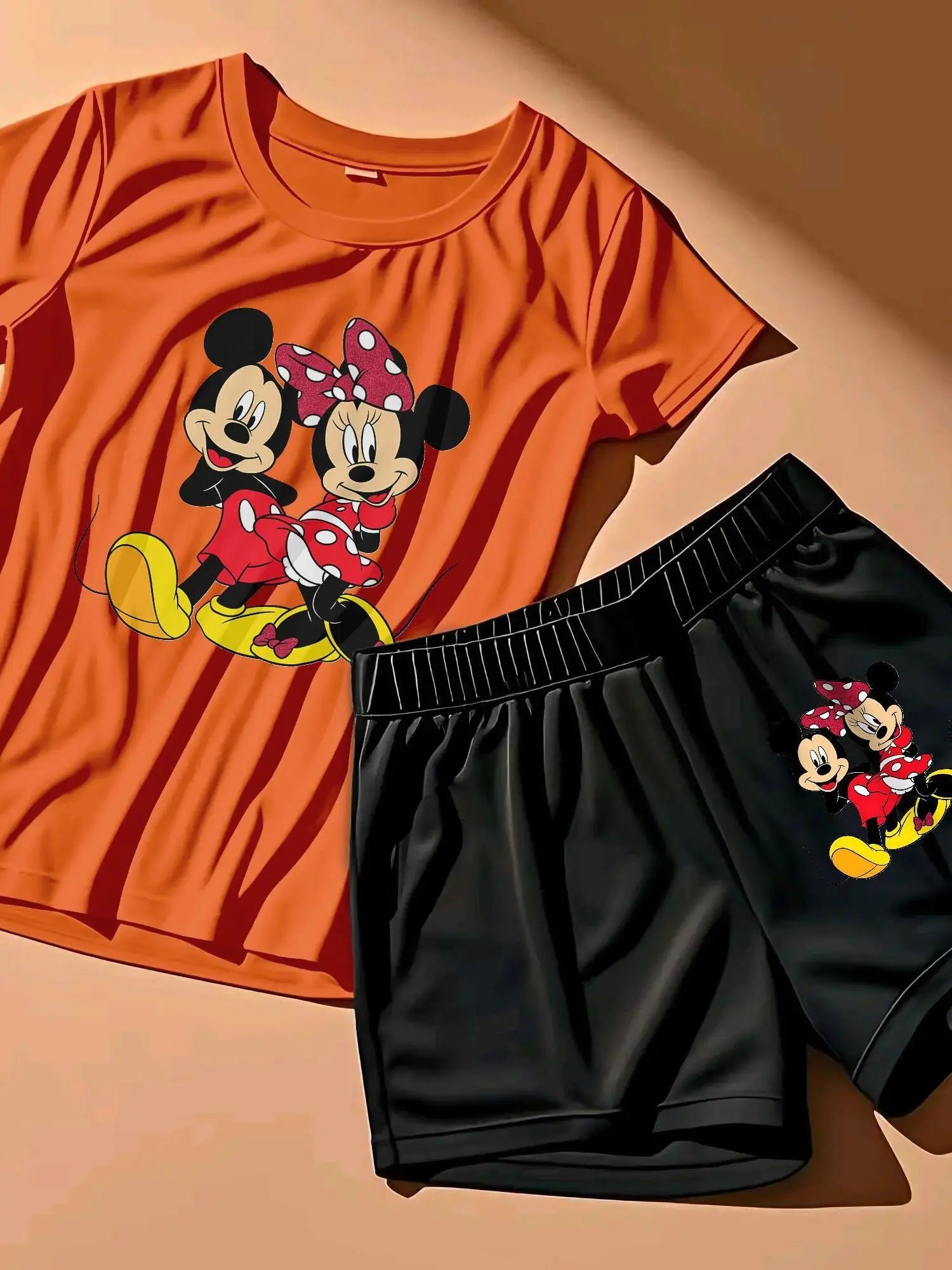 A Two-Piece Outfit Featuring a Printed Short-Sleeve T-Shirt with Dropped Shoulders And Cropped Leggings, Designed for Plus-Size Women, Licensed with Mickey And Minnie. Lady T Fashions